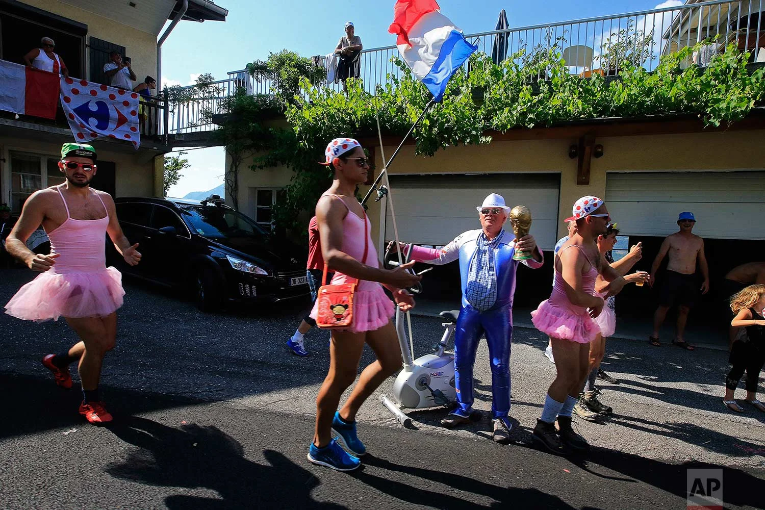 Fans wait for the riders to pass during the tenth stage of the Tour de France cycling race over 158.8 kilometers (98.7 miles) with start in Annecy and finish in Le Grand-Bornand, France, Tuesday, July 17, 2018. (AP Photo/Peter Dejong)
