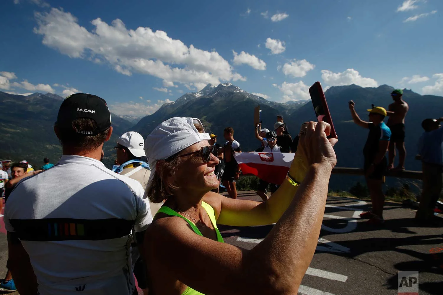 Fans wait in the French Alps for the riders too pass during the eleventh stage of the Tour de France cycling race over 108.5 kilometers (67.4 miles) with start in Albertville and finish in La Rosiere Espace San Bernardo, France. (AP Photo/Christophe Ena )