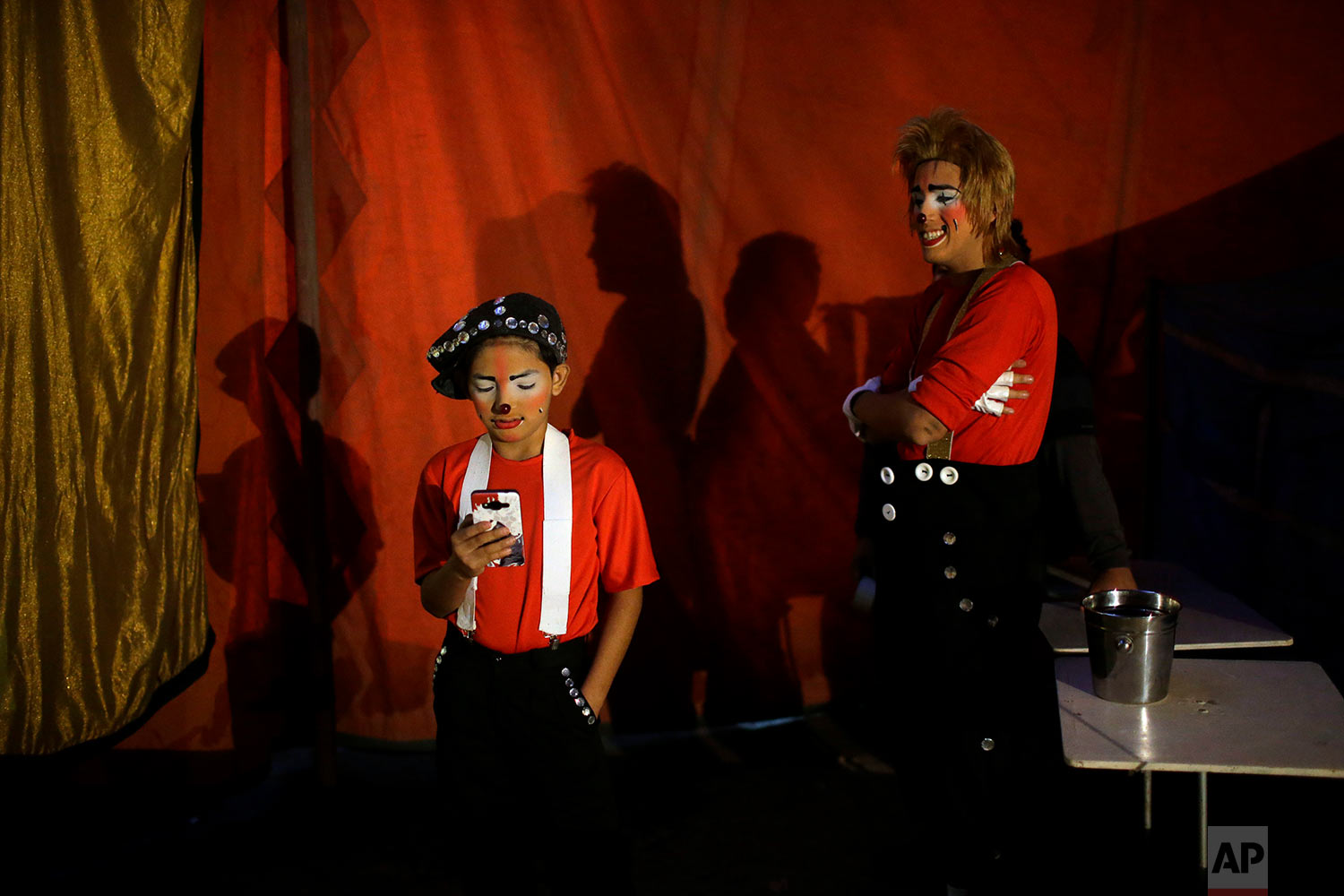  Clowns Joshep Balta, or "Cachupito," left, and Bryan Jara, or "Fideito Mix" wait to open their show at the International Circus set up in the shantytown Pro on the outskirts of Lima, Peru, July 20, 2018. (AP Photo/Martin Mejia) 