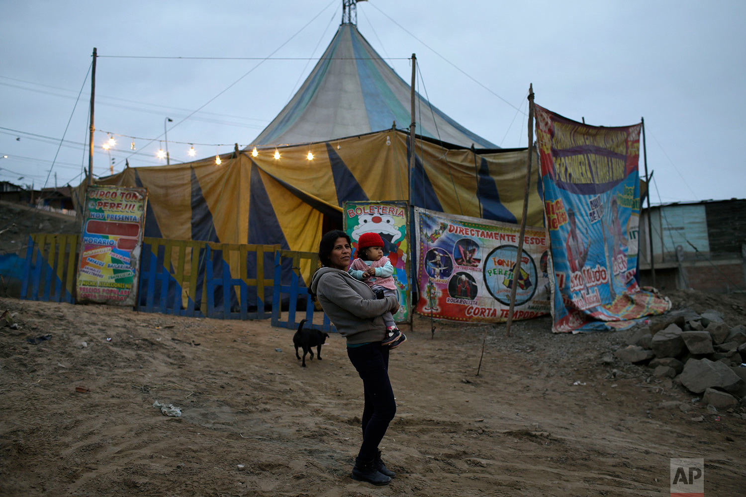  A woman with her baby waits for one of her daughters to arrive before entering the Tony Perejil circus tent, set up in the shantytown of Puente Piedra on the outskirts of Lima, Peru, July 8, 2018. Tickets cost 6 Soles (2 dollars) for adults, and are