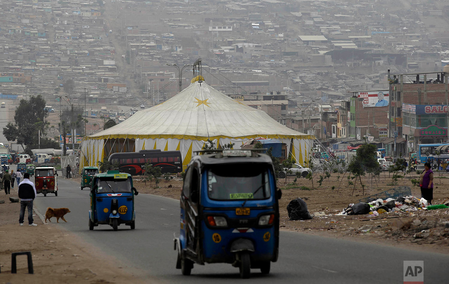  Moto-taxi drivers pass La Panfila Circus tent set up in the shantytown of Villa El Salvador in Lima, Peru, July 13, 2018. (AP Photo/Martin Mejia) 