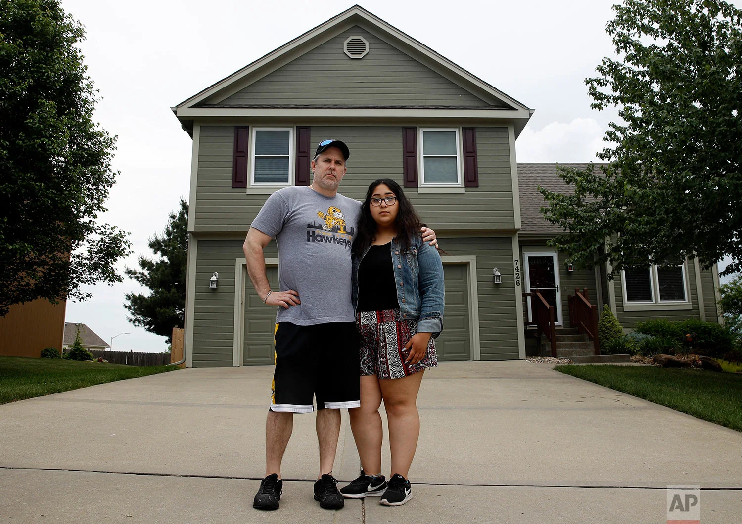 Jennifer Tadeo-Uscanga, 17, and her stepdad Steve Stegall stand outside their Kansas City, Mo. home they shared with wife and mother Letty Stegall. (AP Photo/Charlie Riedel)