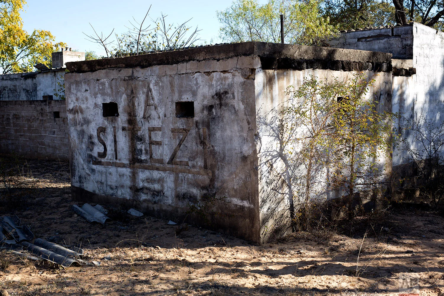 The entrance of the now abandoned Zimbabwean Sitezi military camp is shown, where army soldiers involved in what many called the Matabeleland Massacres. (AP Photo/Jerome Delay)