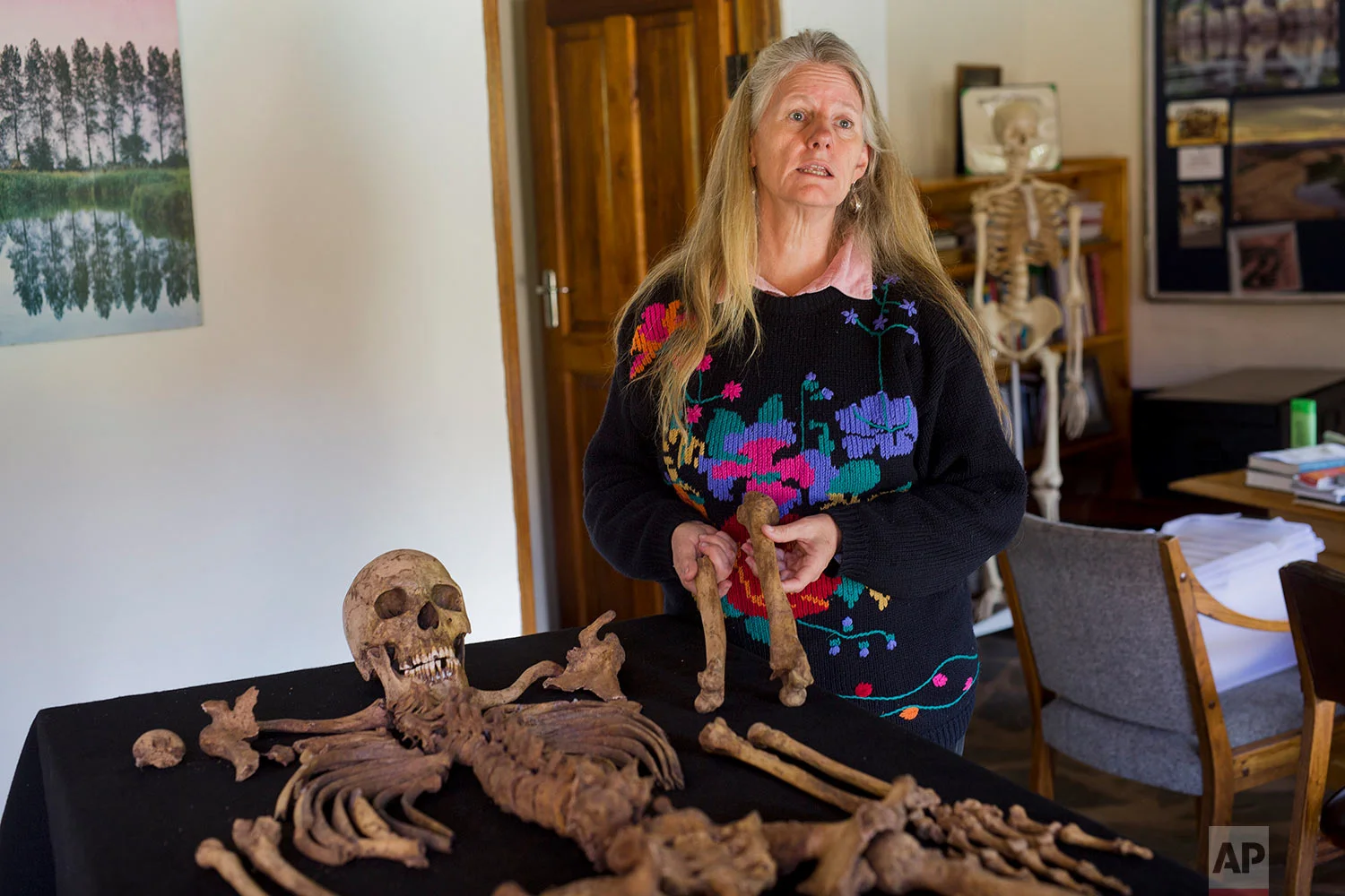 Shari Eppel, director of the Solidarity Peace Trust, holds the remains of Julius Mvulo Nyathi in Bulawayo, Zimbabwe. (AP Photo/Jerome Delay)