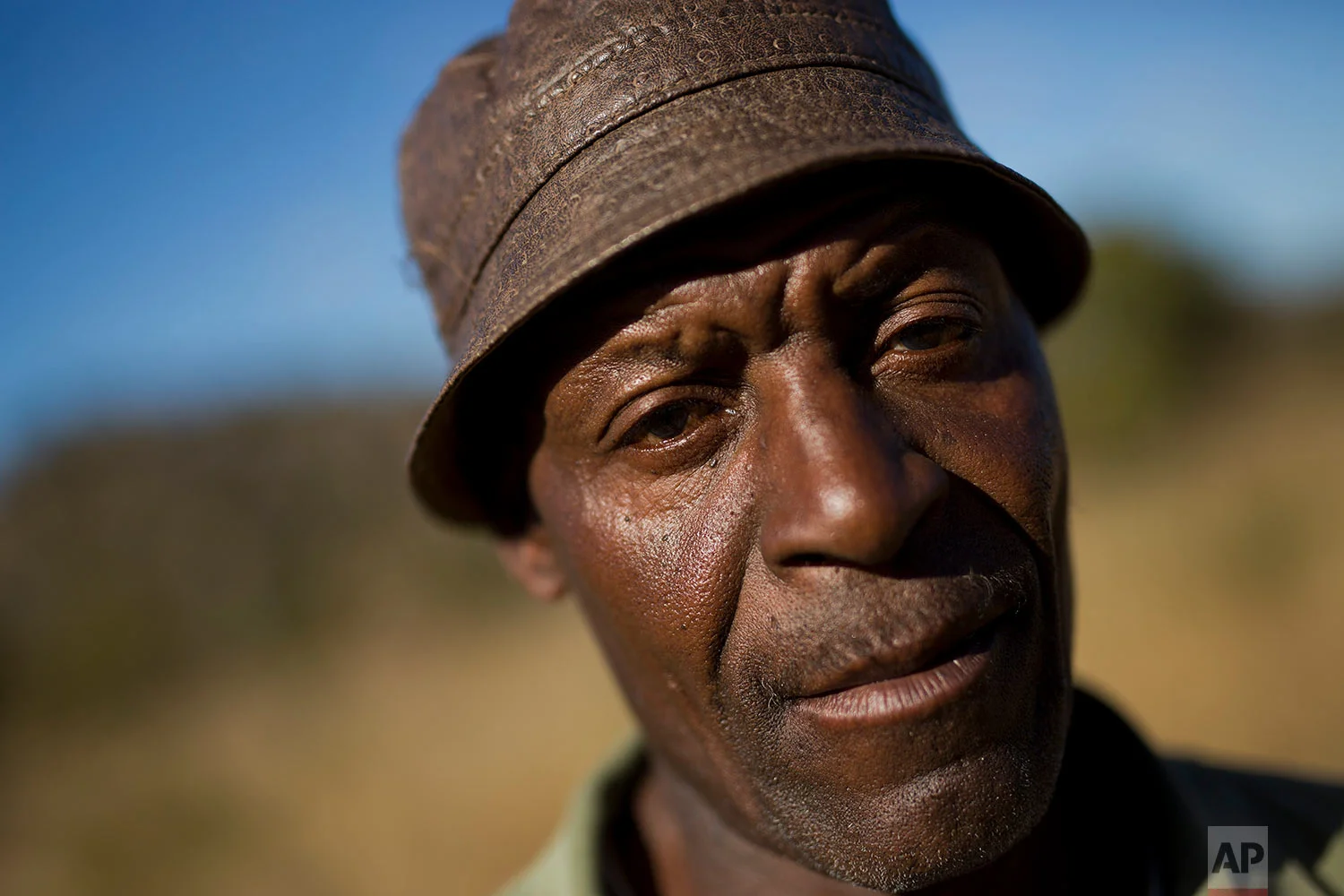 Isaiah Nkomo poses in his fields near the village of Whitewater in the Matobo hills in Zimbabwe. Nkomo has been looking for his missing brother Simimba for over 30 years. Simimba fell victim of Zimbabwean soldiers during the Matabeleland Massacres. (AP Photo/Jerome Delay)