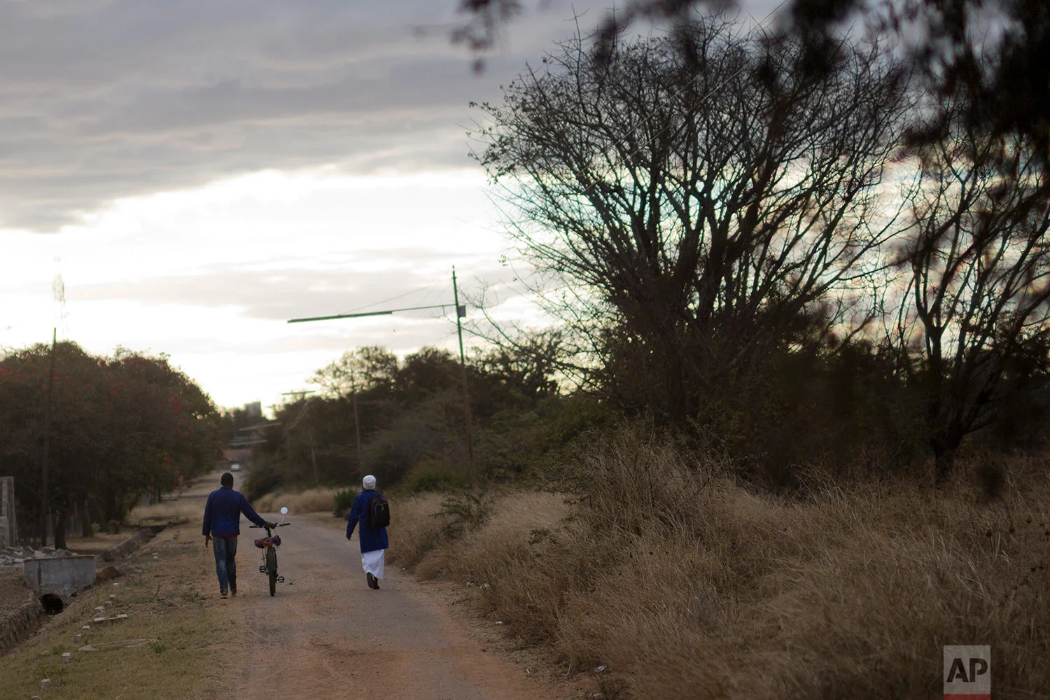 A couple walks back from church in Bulawayo, Zimbabwe. (AP Photo/Jerome Delay)