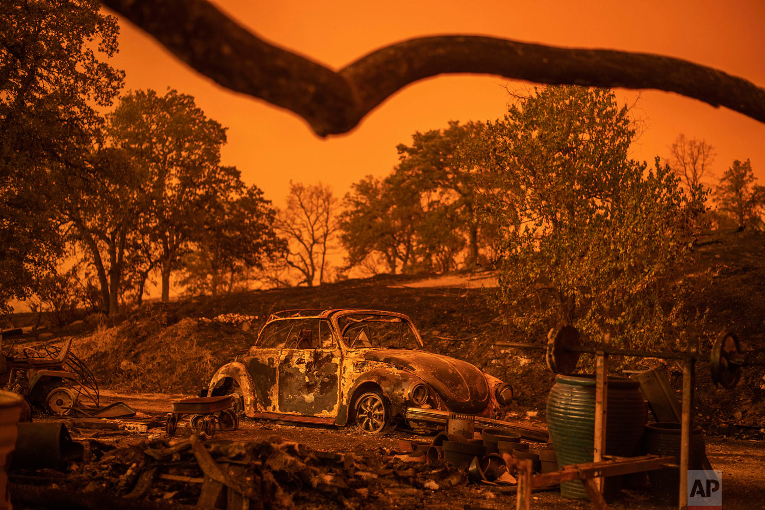  A Volkswagen Beetle scorched by a wildfire called the Carr Fire rests at a residence in Redding, Calif., Friday, July 27, 2018. The wildfire roared with little warning into the Northern California city as thousands of people scrambled to escape befo