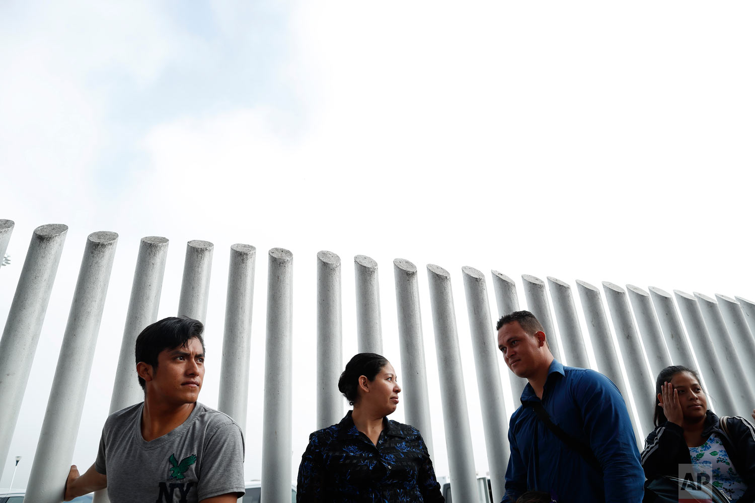  People form a line to cross into the U.S. to begin the process of applying for asylum Thursday, July 26, 2018, near the San Ysidro port of entry in Tijuana, Mexico. As the Trump administration faced a court-imposed deadline Thursday to reunite thous