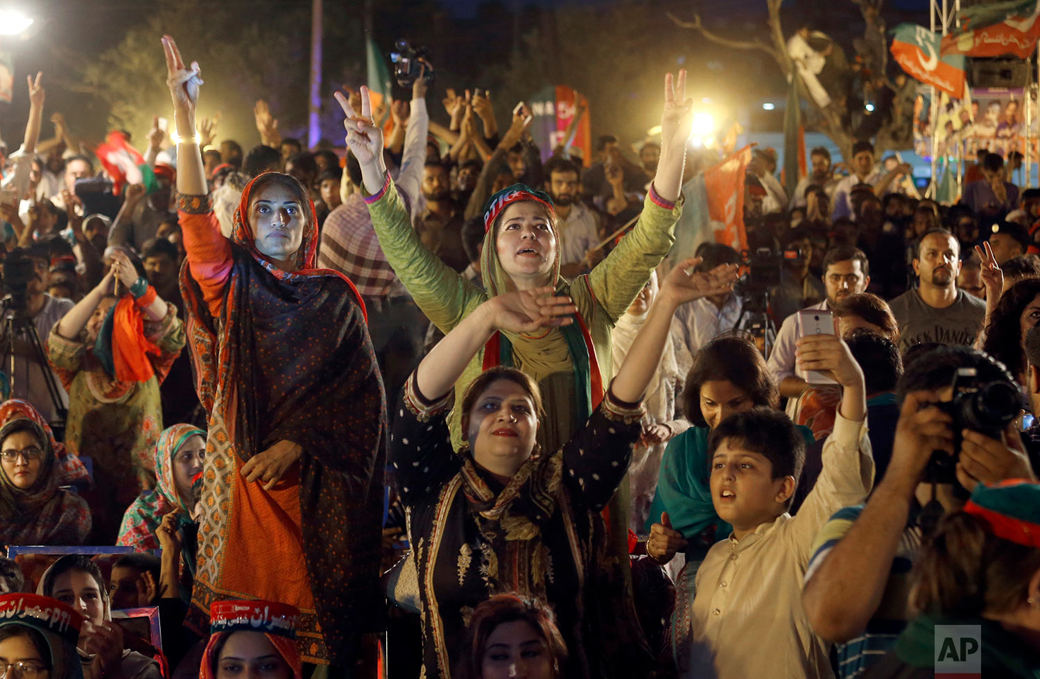  Supporters of Tehreek-e-Insaf party greet to their leader Imran Khan during an election campaign rally in Islamabad, Pakistan, Saturday, July 21, 2018. (AP Photo/Anjum Naveed) 