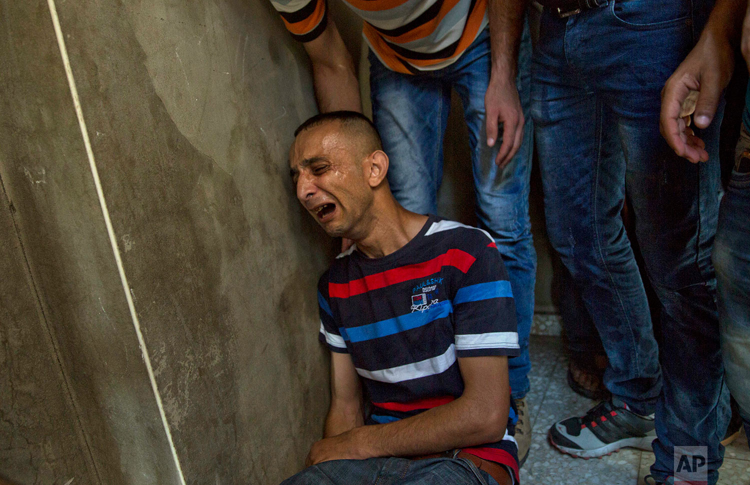  A Palestinian relative of Mohammed Badwan, 27, who was shot and killed by Israeli troops on Friday's ongoing protest at the Gaza Strip's border with Israel, mourns at the family home during his funeral in Gaza City, Saturday, July 21, 2018. (AP Phot