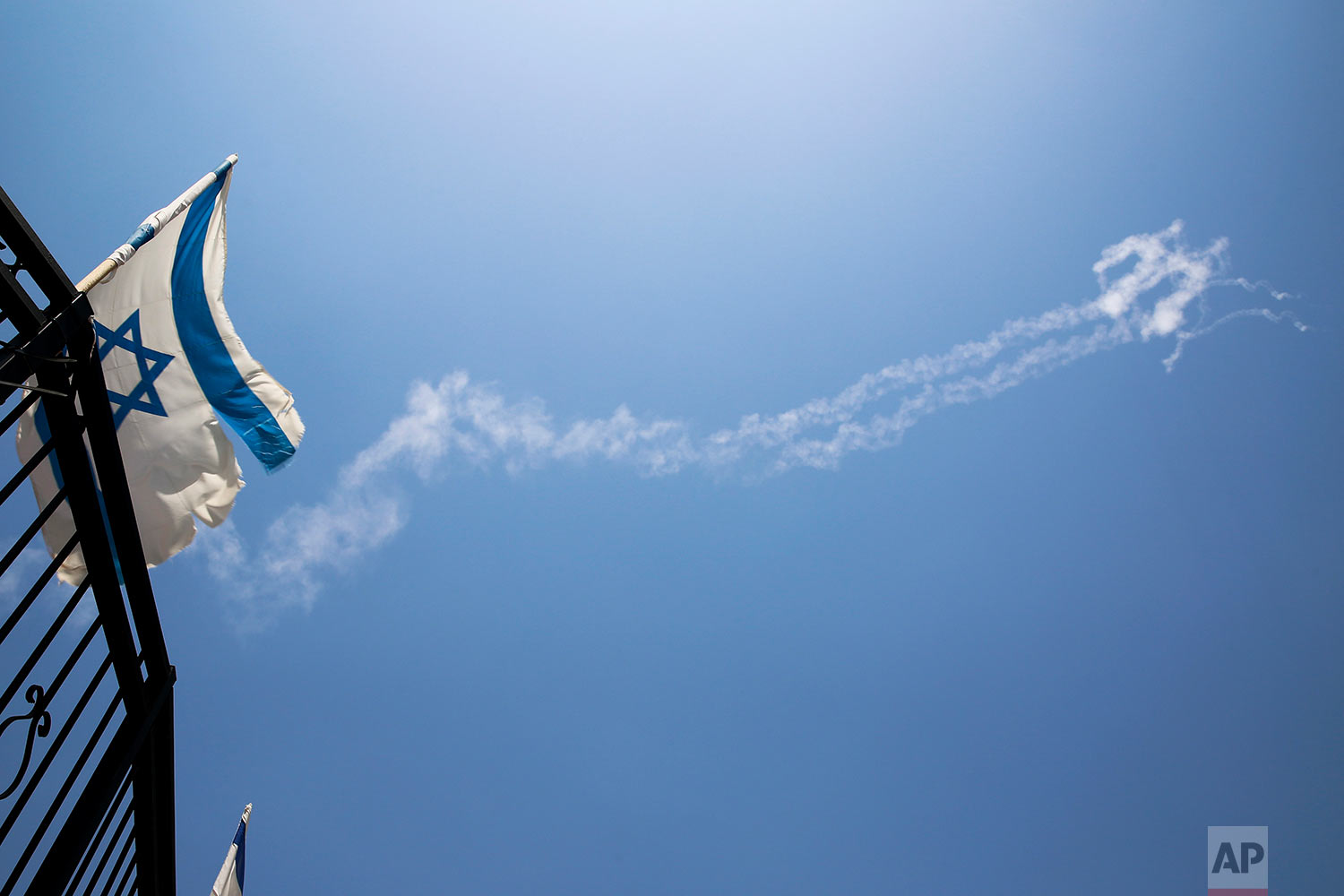  Trails of Patriot missiles are seen in the sky in northern Israel Tuesday, July 24, 2018. Israel shot down a Syrian fighter jet it said had breached its airspace on Tuesday while advancing Syrian government forces retaking territory from rebels reac