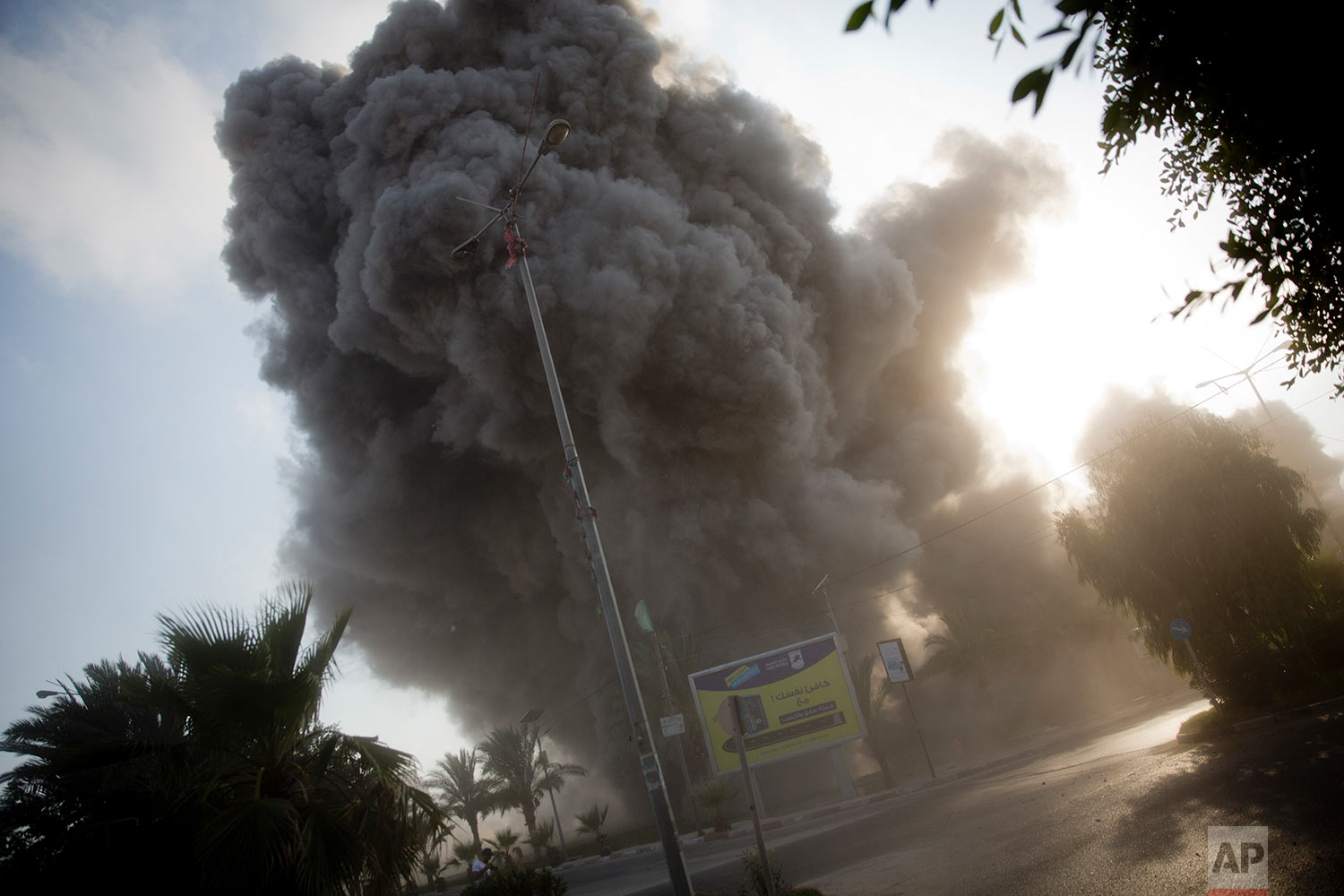  Smoke raises in the background following an Israeli airstrike hits a governmental building in Gaza City , Saturday, July 14, 2018.(AP Photo/Khalil Hamra) 
