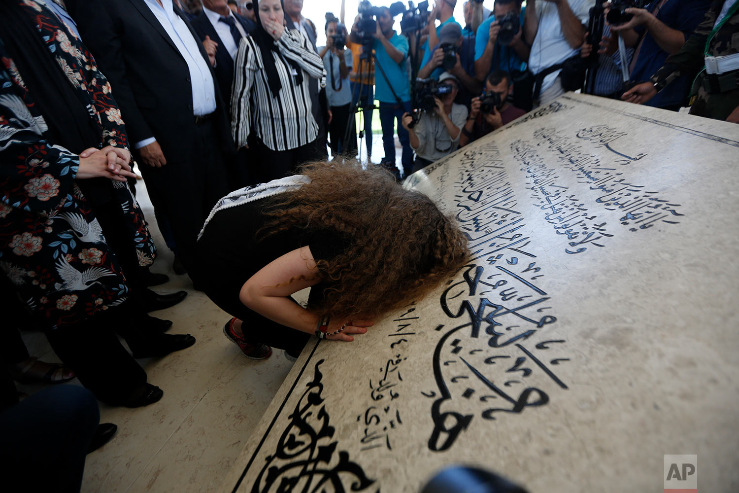  Ahed Tamimi prays at the tomb of former Palestinian leader Yasser Arafat in the West Bank city of Ramallah, Sunday, July 29, 2018. Palestinian protest icon Ahed Tamimi and her mother Nariman returned home to a hero's welcome in her West Bank village