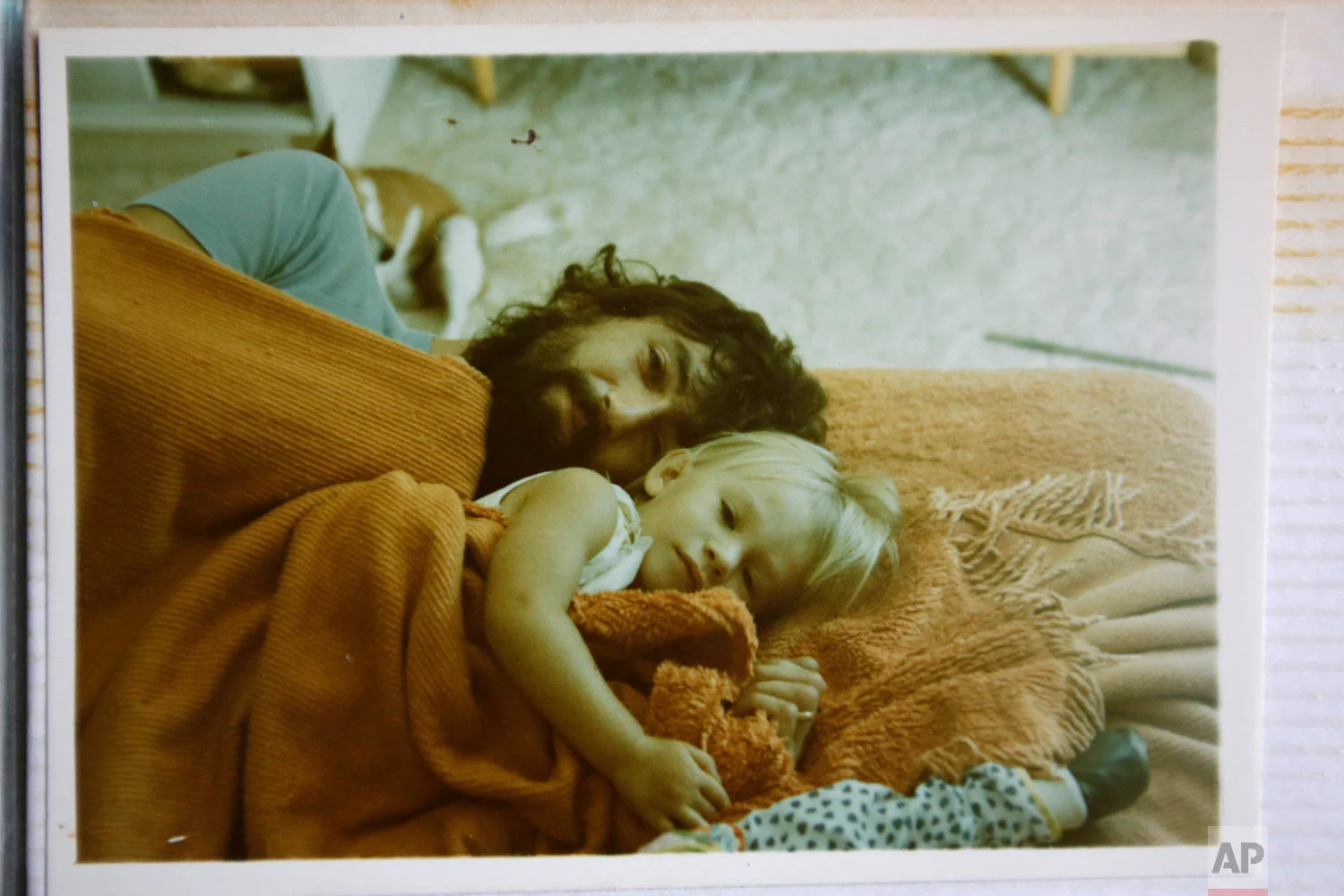 A photograph of Peter Peacock and his elder daughter, Melanie, in 1979, as they lay on the floor, in Melbourne, Australia. (AP Photo/Wong Maye-E)