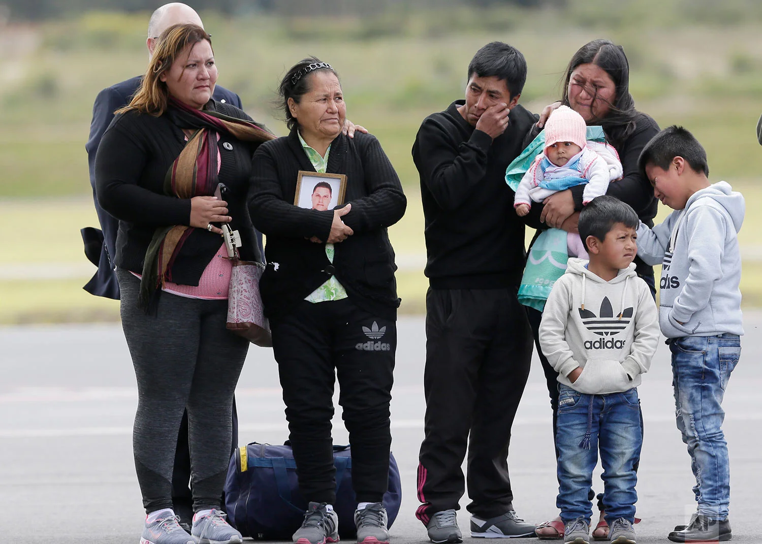 Relatives and friends wait for the remains of Katty Velasco and Oscar Villacis, to arrive at the Mariscal Sucre airport in Quito, Ecuador, July 6, 2018. The two were kidnapped three months ago and later killed by a dissident group of the Revolutionary Armed Forces of Colombia on the border with Colombia. (AP Photo/Dolores Ochoa)