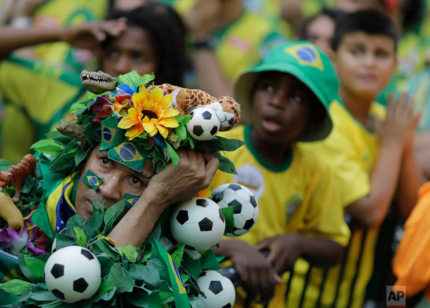 Brazil soccer fans react at the end of a live broadcast of a World Cup quarterfinal match with Belgium in Rio de Janeiro, Brazil, July 6, 2018. Belgium knocked Brazil out of the World Cup and advanced to the semi-finals. (AP Photo/Leo Correa)