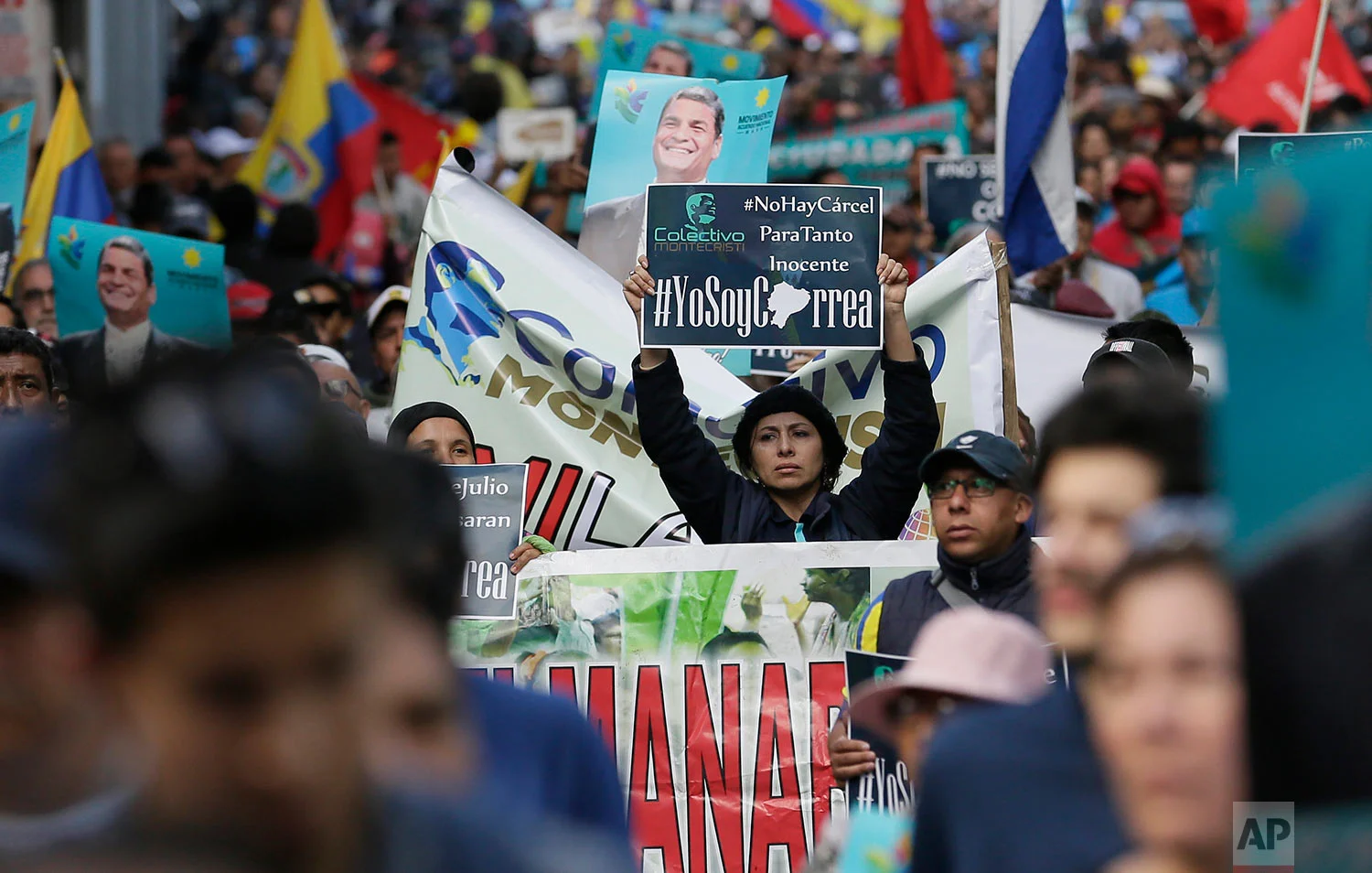 Supporters of former President Rafael Correa rally in his favor after a judge ordered him jailed for failing to appear in court as required as part of a kidnapping probe in Quito, Ecuador, July 5, 2018. (AP Photo/Dolores Ochoa)