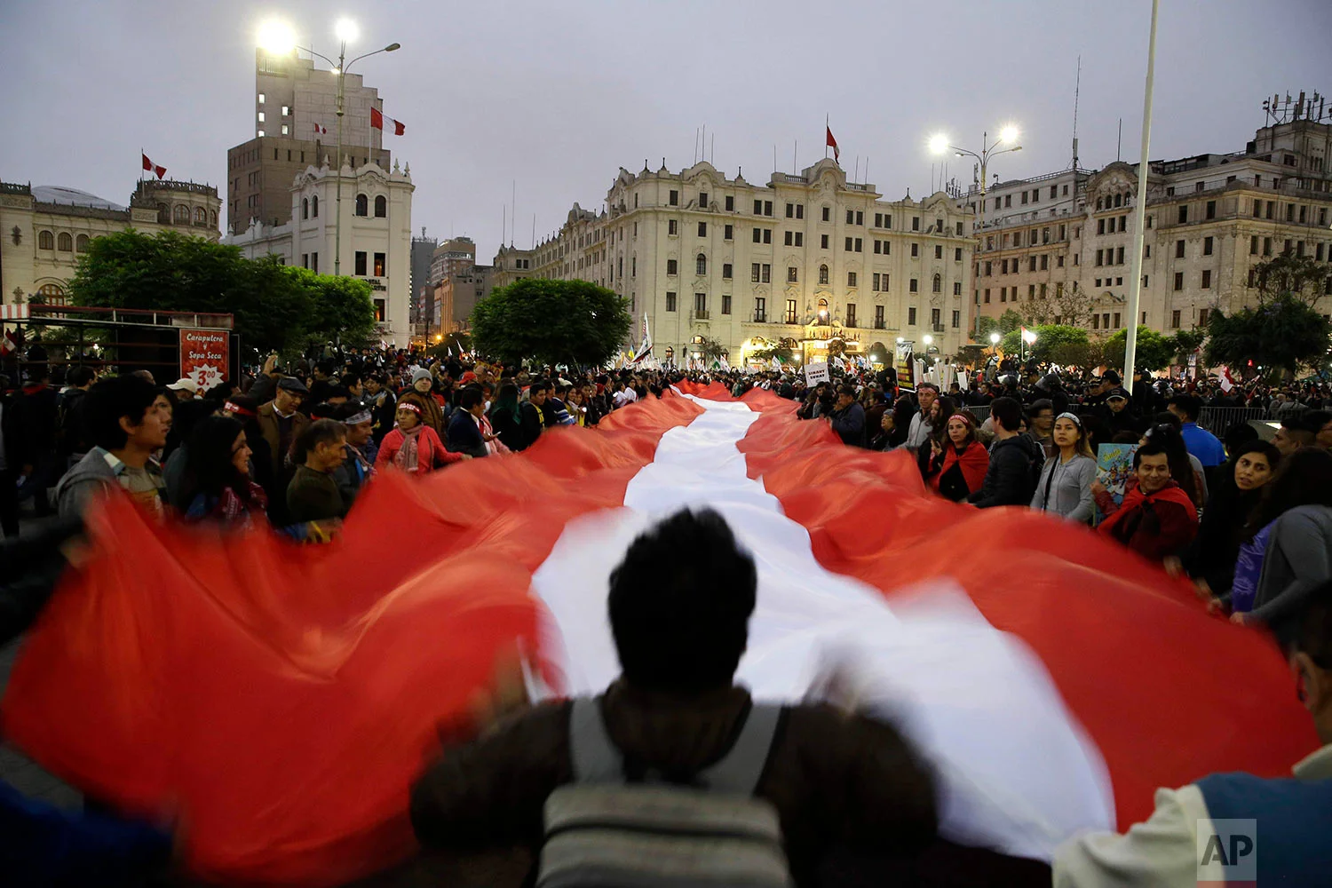 Demonstrators protest corruption at San Martin plaza in Lima, Peru, July 19, 2018. The latest scandal to embroil this South American nation has ensnared some of the country's highest-ranking judges and political officials and comes just four months after then-President Pedro Pablo Kuczynski stepped down in a separate corruption probe. (AP Photo/Martin Mejia)
