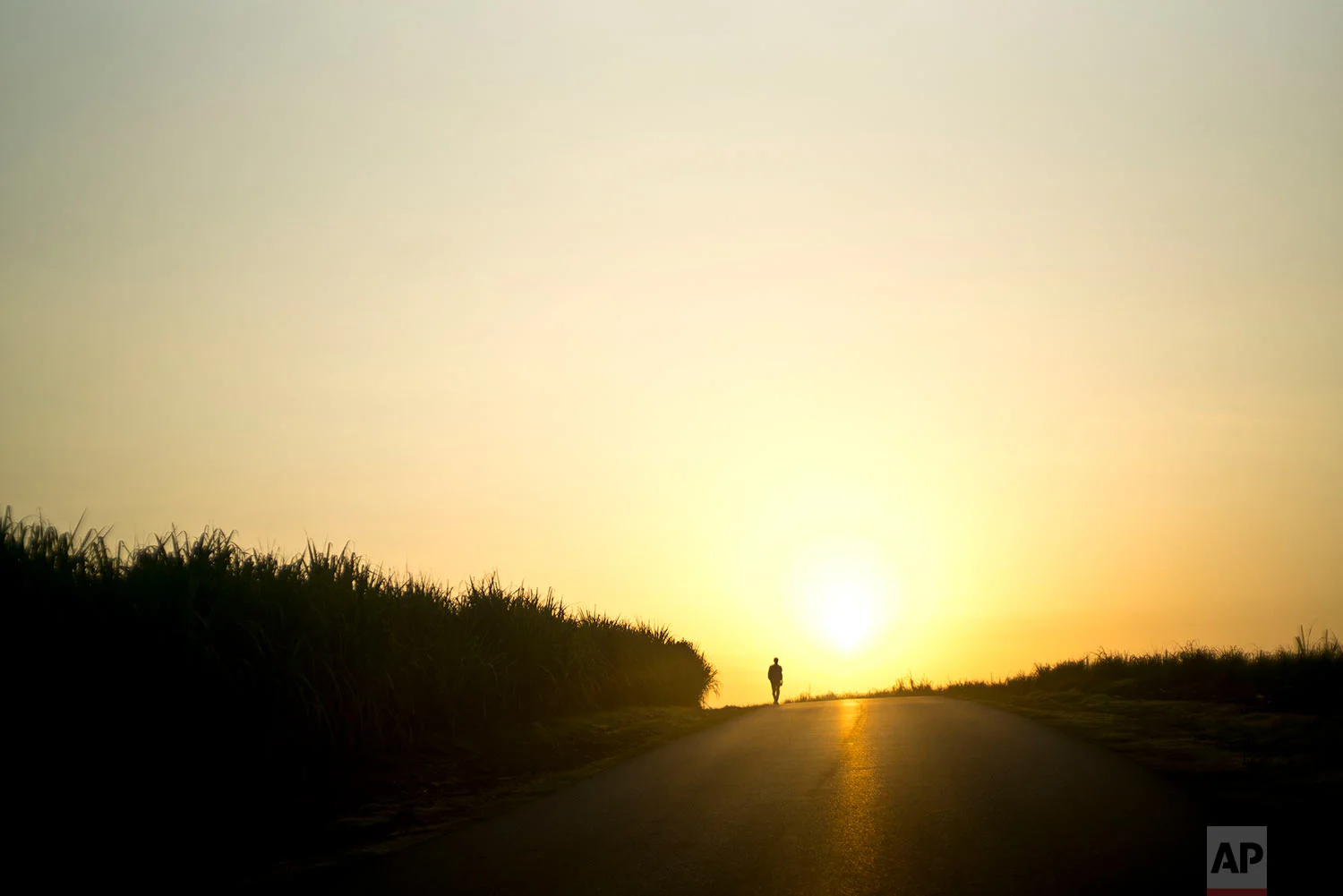A man walks along a road at dawn, away from Guantanamo, Cuba, July 25, 2018. 