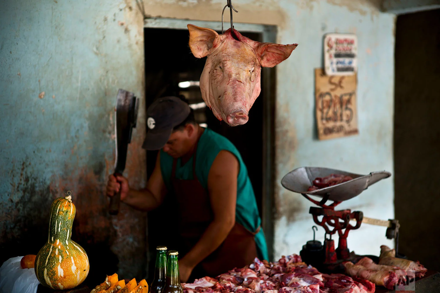A butcher works in Guantanamo, Cuba, July 25, 2018. Pork is the most accessible meat in Cuba, where the pig has its own song: "El Puerco Mamifero Nacional," or National Mammal Pork," sung by the Buena Fe band.