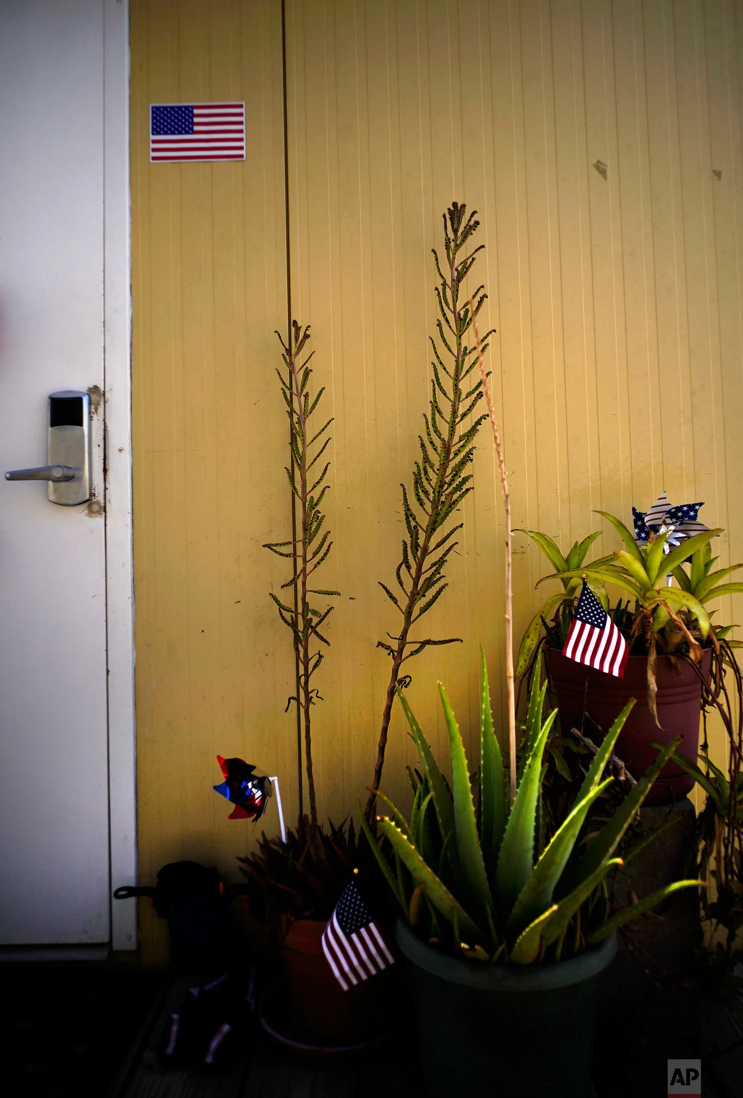 Flags decorate the entrance to a soldier barracks on the naval base at Guantanamo Bay, June 6, 2018. This barrack had two beds separated by a wall, and one bathroom. 