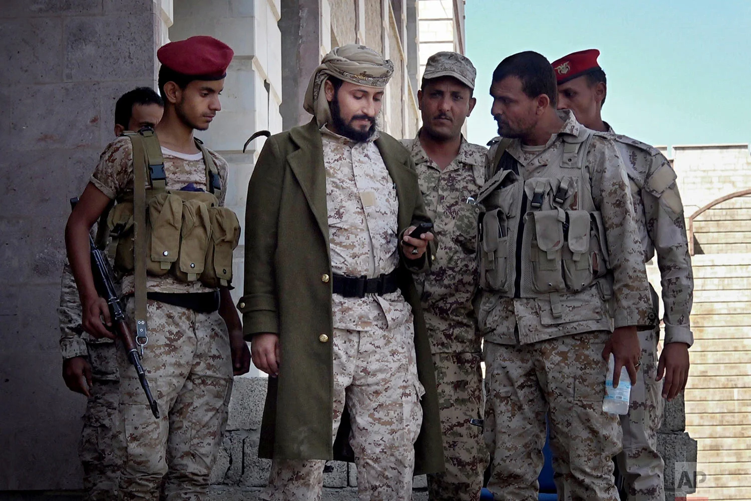 Adnan Rouzek, center, stands with fighters in Taiz. (AP Photo)