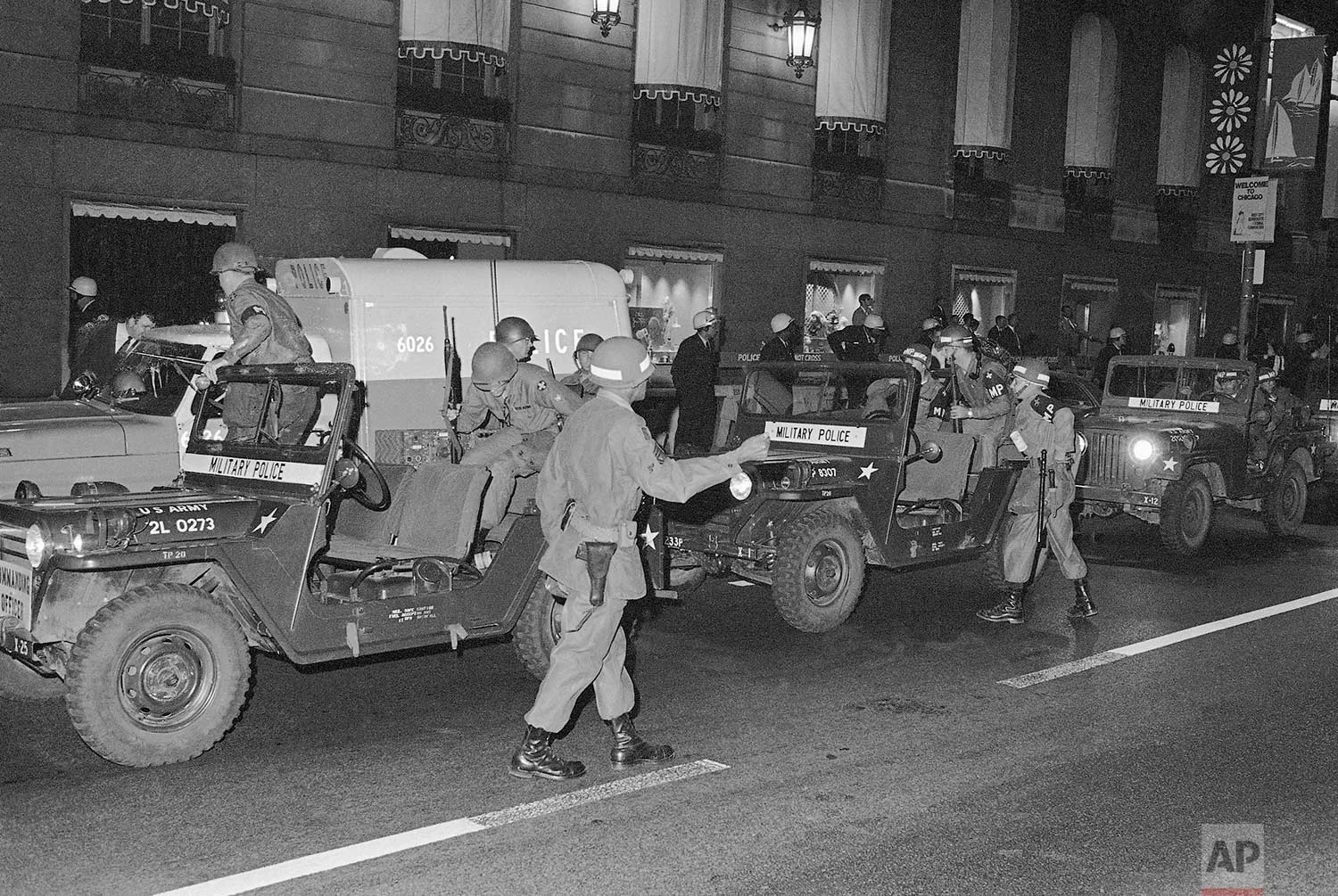 A demonstrator jeers at National Guardsmen in front of the Hilton Hotel in Chicago on Aug. 28, 1968. About 800 troops armed with rifles surrounded the hotel as 2,500 hippies and anti-war protesters gathered to demonstrate. (AP Photo)