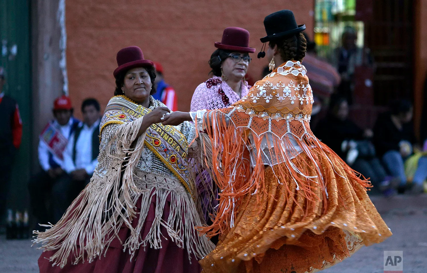 Festival founder Libia Espinoza, left, dances with transgenders Coco and Jessi during festivities honoring Our Lady of Copacabana, in Cuzco, Peru, Aug. 5, 2018. (AP Photo/Martin Mejia)