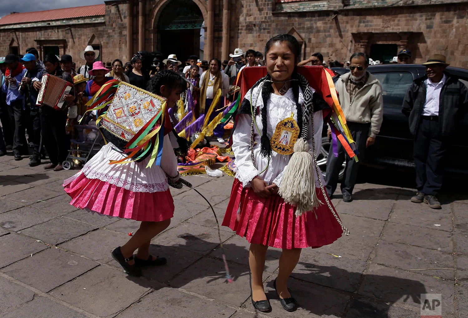  A dancer winces in pain as she is whipped by a fellow dancer in an adaptation of the Inca warrior dance known as "Kachampa", during celebrations honoring Our Lady of Copacabana, in Cuzco, Peru, Aug. 5, 2018. (AP Photo/Martin Mejia) 