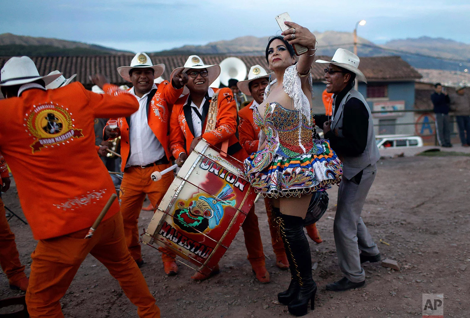  Transgender Carolina, dressed as a "china", poses for a photo with Majestic Union band members during celebrations honoring Our Lady of Copacabana, in Cuzco, Peru, Aug. 5, 2018. Carolina says she and her friends are invited every year to take part i
