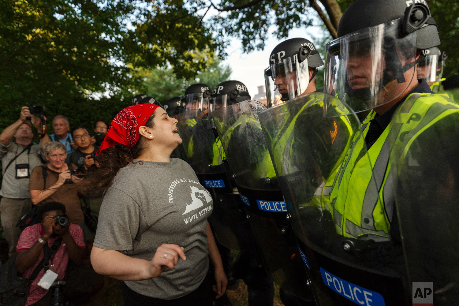  Emily Filler attempts to dissuade state police from advancing on students rallying on the grounds of the University of Virginia on the anniversary of the "Unite the Right" rally in Charlottesville, Va. Saturday, Aug. 11, 2018.  (Craig Hudson/Charles