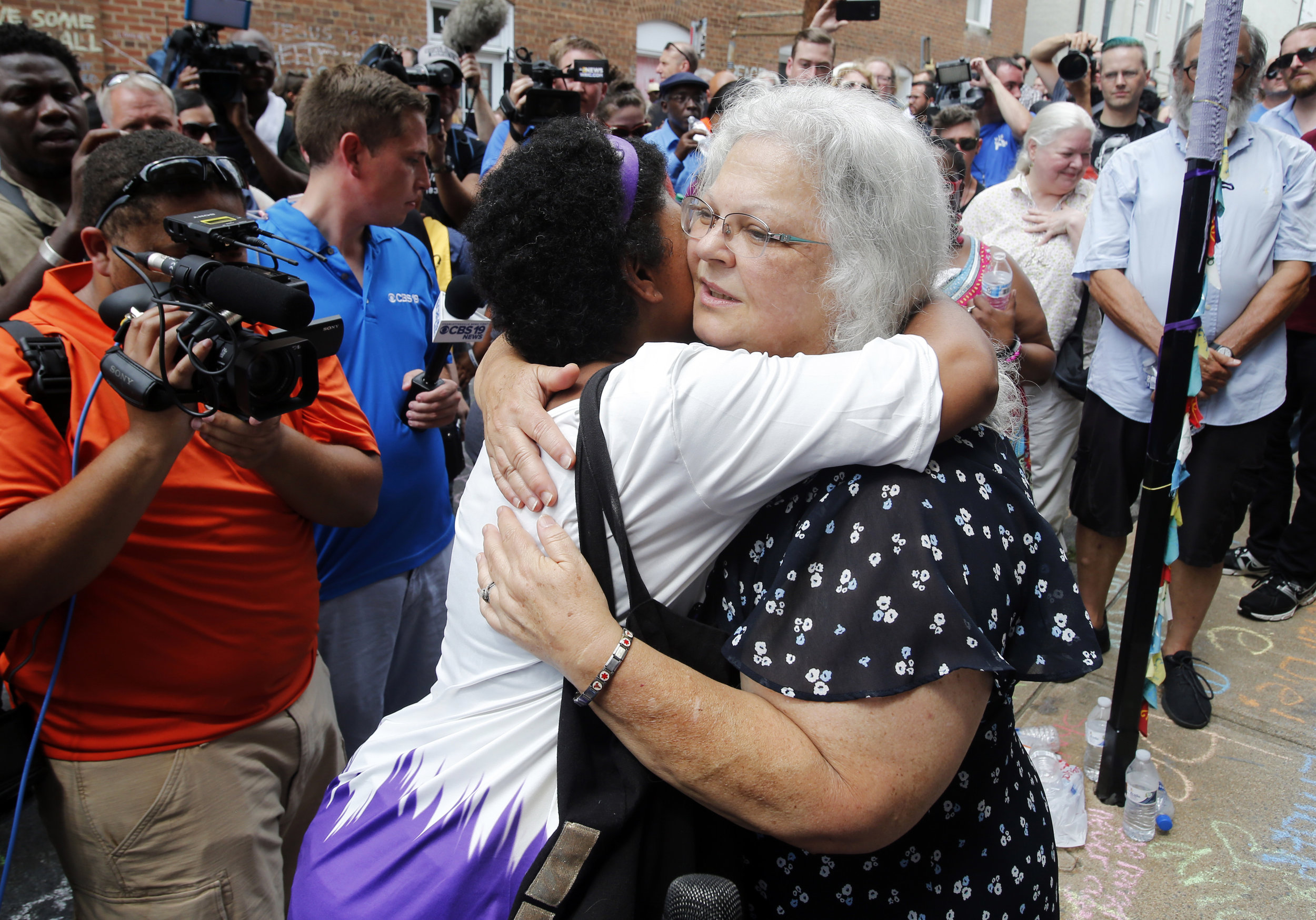  Susan Bro, mother of Heather Heyer who was killed during last year's Unite the Right rally, embraces supporters after laying flowers at the spot her daughter was killed in Charlottesville, Va., Sunday, Aug. 12, 2018. Bro said there's still "so much 