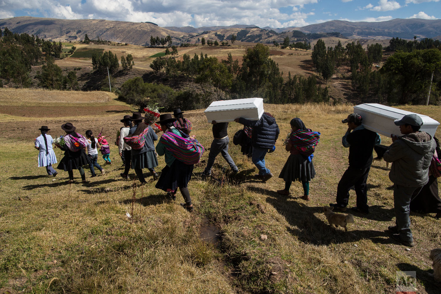  In this Aug. 15, 2018 photo, villagers carry the remains of people killed by the Shining Path guerrillas in 1984, during their proper burial in Tantana, in Peru's Ayacucho province. (AP Photo/Rodrigo Abd) 