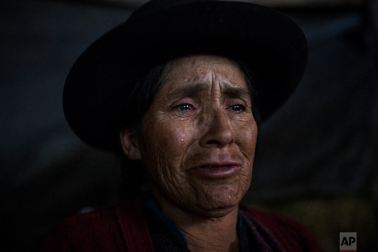  In this Aug. 15, 2018 photo, Antonia Yupanki Tineo, 58, cries near the coffin of her uncle Alejandro Tineo, who was killed by Shining Path guerrillas in 1984, as she attends his proper burial in Quinuas, in Peru's Ayacucho province. (AP Photo/Rodrig