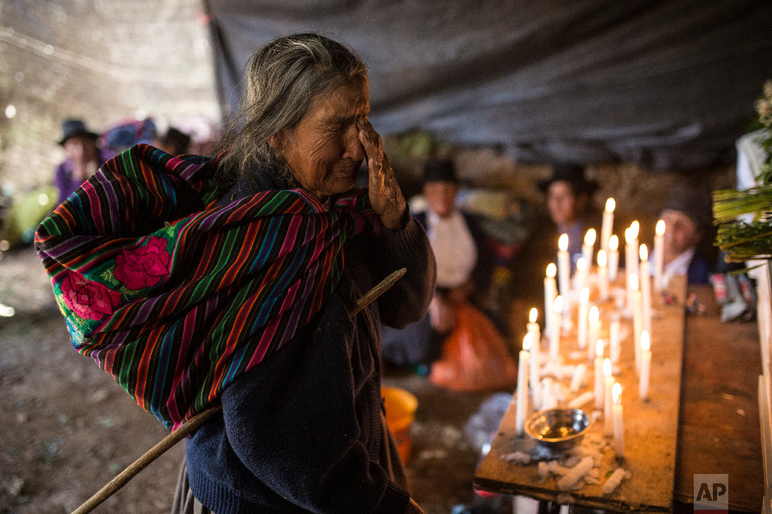  In this Aug. 15, 2018 photo, Paulina Tineo Canchari cries as she stands before the many coffins of relatives killed by the Shining Path guerrillas and the Peruvian army in the 1980s, during their proper burial in Quinuas, in Peru's Ayacucho province