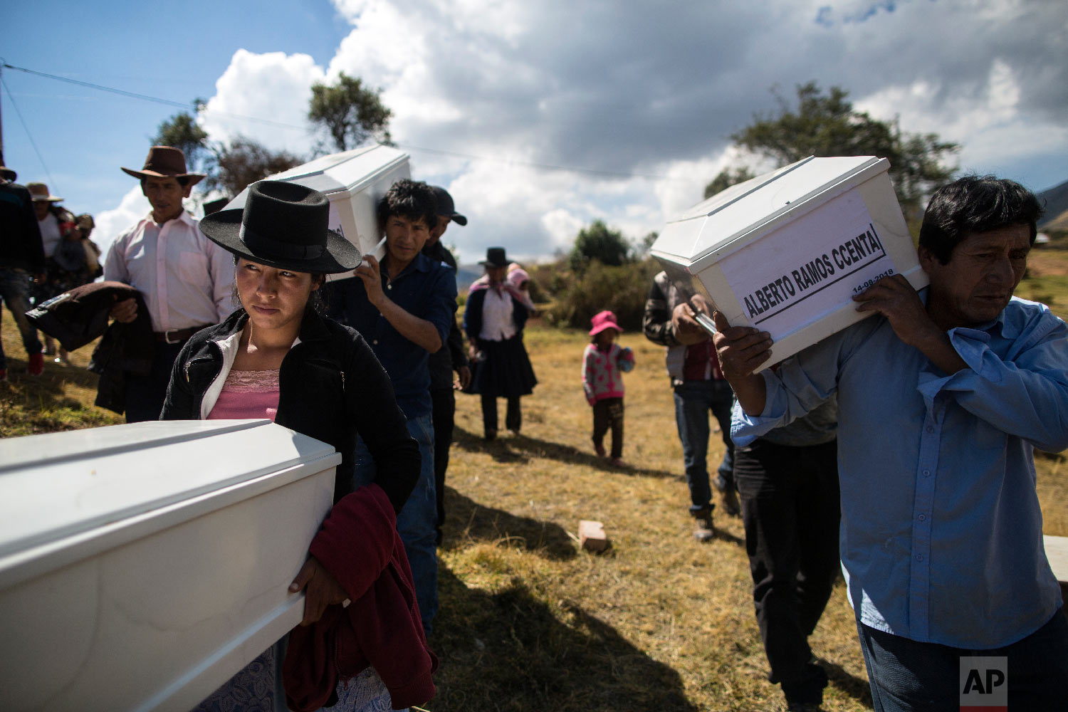  In this Aug. 15, 2018 photo, the relatives of people who were killed by the Shining Path guerrillas and the Peruvian army in the 1980s carry their remains to the cemetery for a proper burial in Quinuas, in Peru's Ayacucho province. (AP Photo/Rodrigo