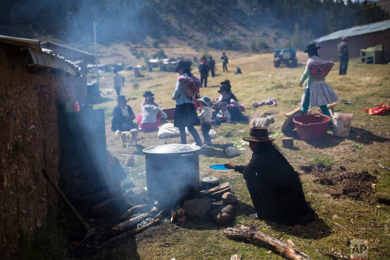  In this Aug. 15, 2018 photo, the relatives of villagers who were killed by the Shining Path guerrillas and the Peruvian army in the 1980s cook lunch after giving their loved ones a proper burial in Quinuas, in Peru's Ayacucho province. (AP Photo/Rod