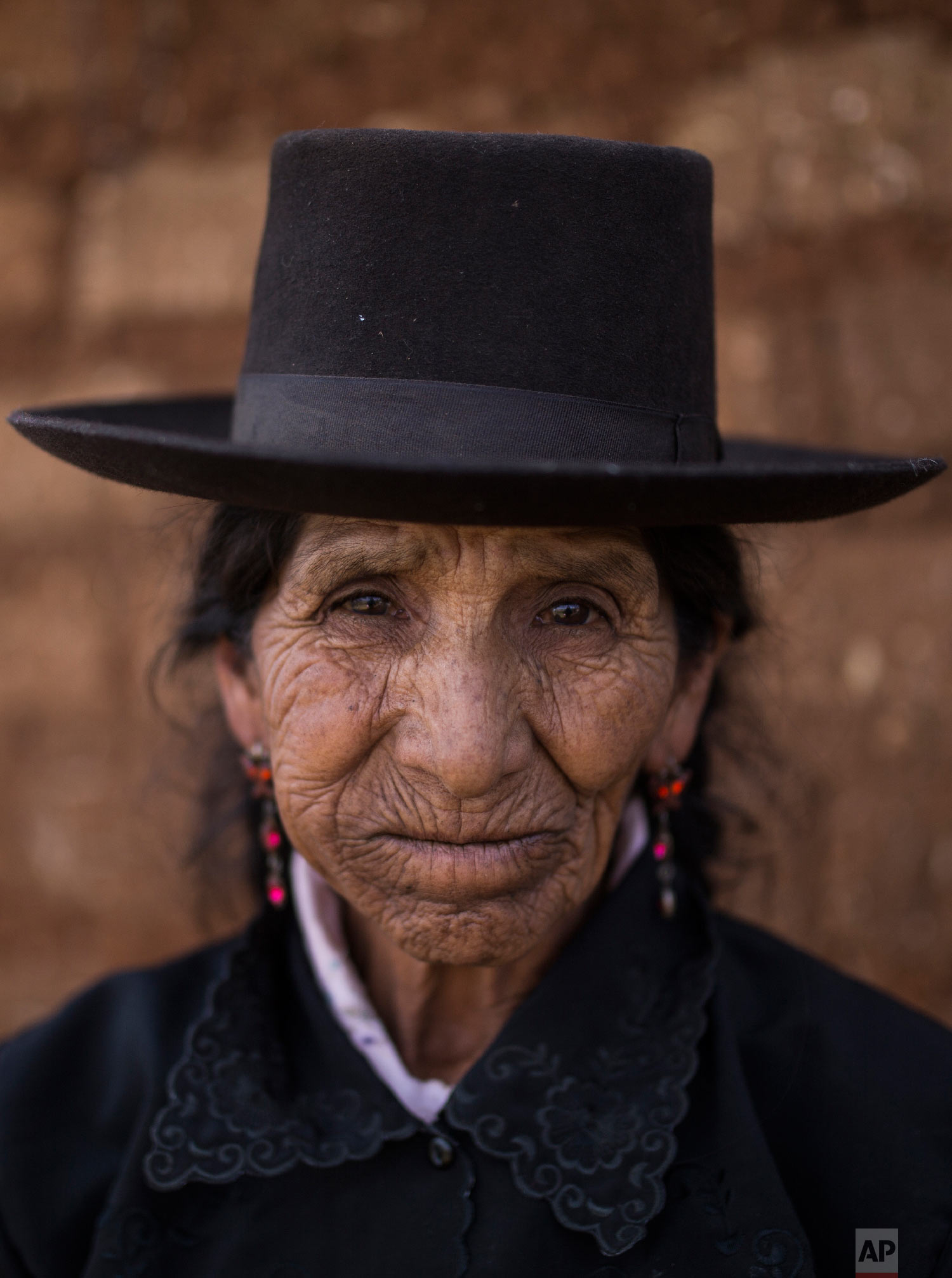  In this Aug. 15, 2018 photo, Maria Magdalena Espinosa, whose husband Daniel Tineo was  killed by the Shining Path guerrillas in 1984, poses for a portrait outside her home in Tantana, in Peru's Ayacucho province. (AP Photo/Rodrigo Abd) 