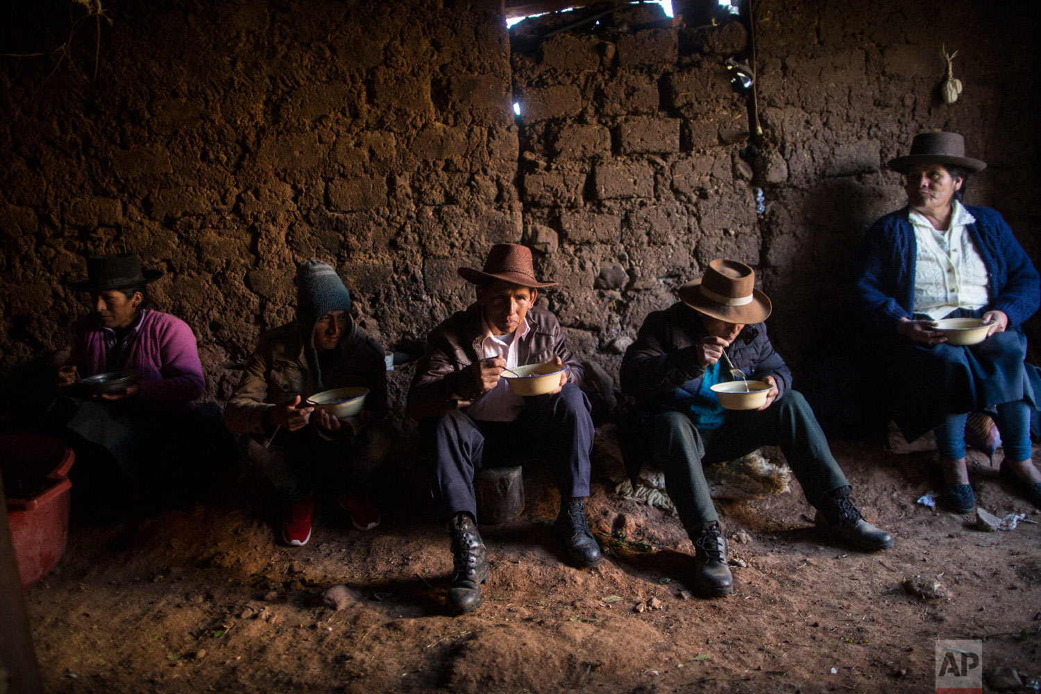  In this Aug. 15, 2018 photo, villagers eat breakfast before giving a proper burial to their loved ones who were killed by Shining Path guerrillas and the Peruvian army in the 1980s, in Quinuas, in Peru's Ayacucho province. (AP Photo/Rodrigo Abd) 