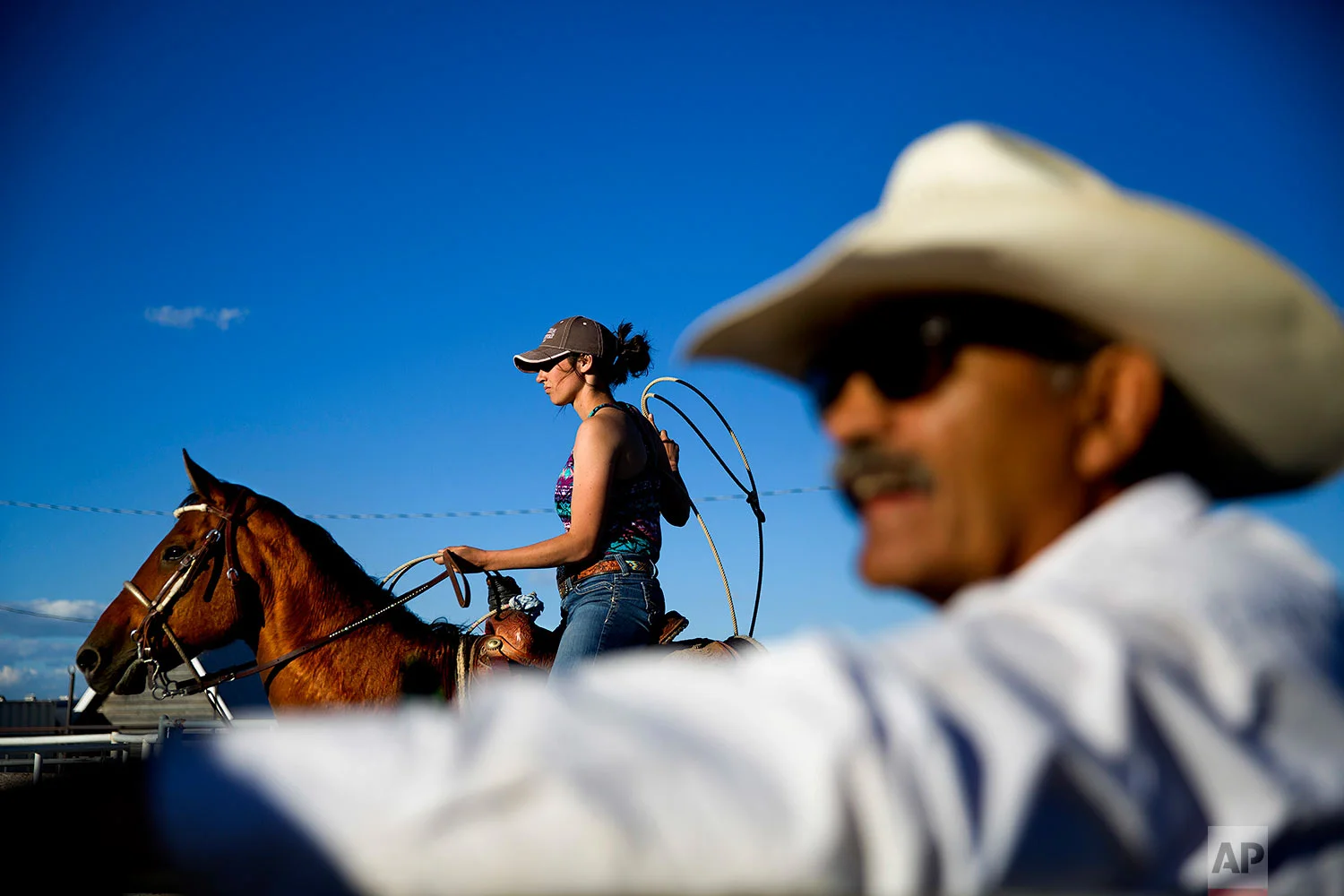 A female contestant waits to rope a calf during a practice run for a rodeo competition on the Blackfeet Indian Reservation in Browning, Mont., July 10, 2018. (AP Photo/David Goldman)