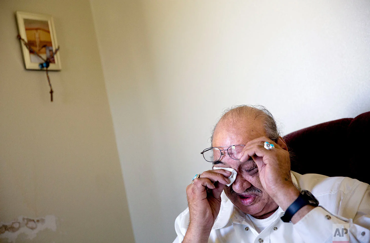 Kenny Still Smoking wipes his eye while talking about his 7-year-old daughter, Monica, who disappeared from school in 1979 and was found frozen to death on a mountain, as he sits in his home on the Blackfeet Indian Reservation in Browning, Mont., July 12, 2018. (AP Photo/David Goldman)