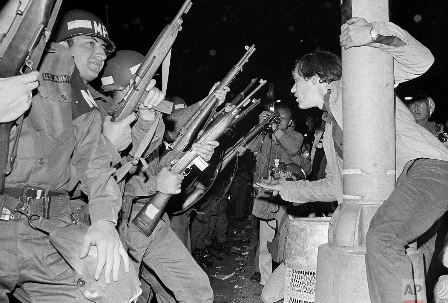 Jeers greet Chicago police officers as they attempt to disperse demonstrators outside the Conrad Hilton, Democratic Convention headquarters hotel Wednesday, August 29, 1968. (AP Photo/RHS)