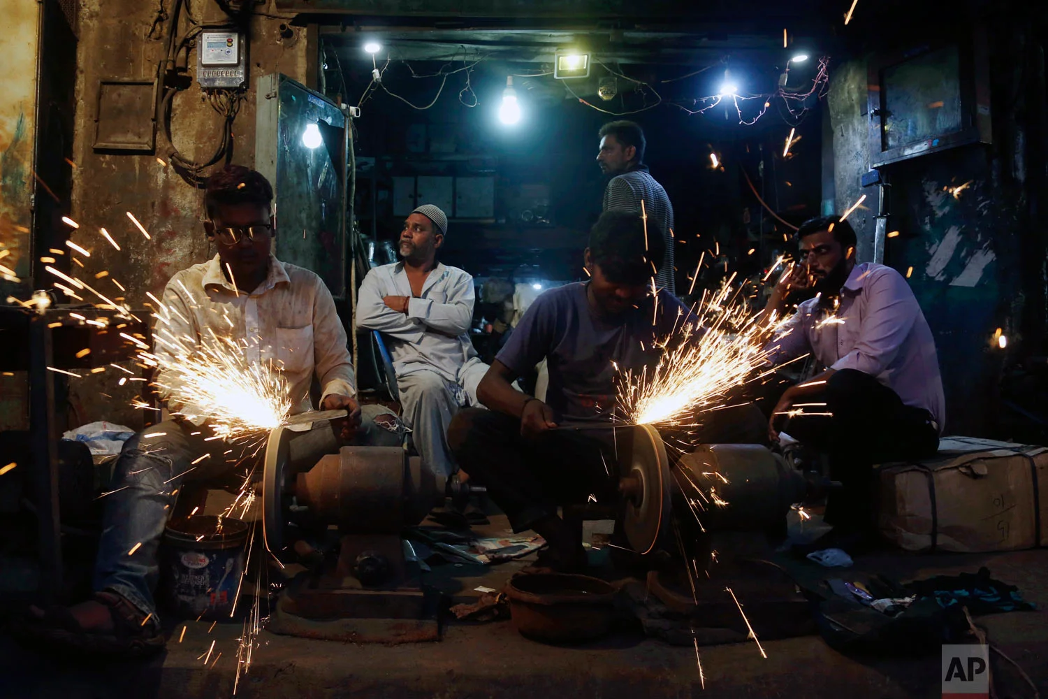 People have their knives sharpened for the upcoming Muslim festival Eid al-Adha in Karachi, Pakistan, Monday, Aug. 20, 2018. Eid al-Adha, or Feast of Sacrifice, is the most important Islamic holiday and marks the willingness of the Prophet Ibrahim (Abraham to Christians and Jews) to sacrifice his son. (AP Photo/Shakil Adil)