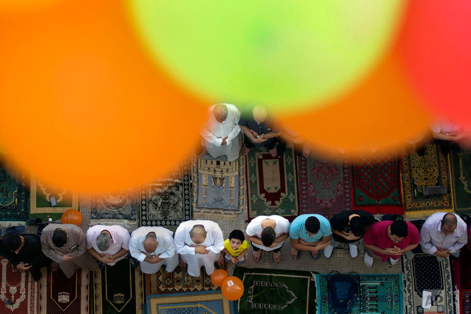 Muslims offer Eid al-Adha prayers outside al-Seddik mosque in Cairo, Egypt, Tuesday, Aug. 21, 2018. During the holiday, which in most places lasts four days, Muslims slaughter sheep or cattle, distribute part of the meat to the poor and eat the rest. (AP Photo/Amr Nabil)