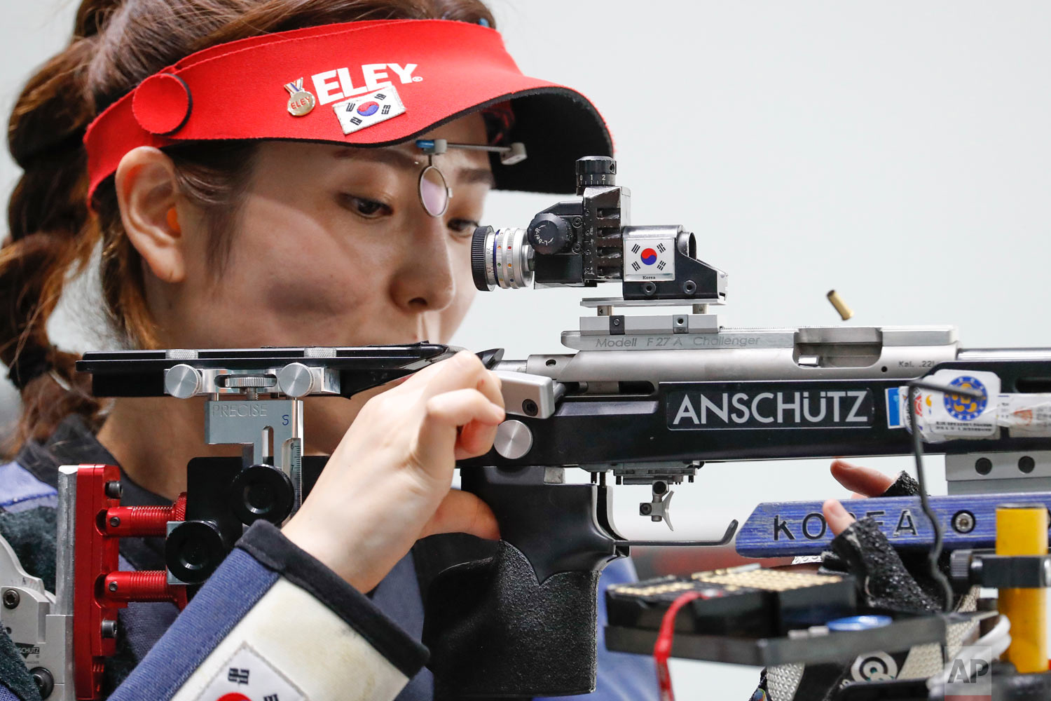South Korea's Jeong Mira clears her rifle barrels during the shoots in the final round of the 50m rifle 3 positions women's shooting event during the 18th Asian Games in Palembang, Indonesia, Wednesday, Aug. 22, 2018. (AP Photo/Vincent Thian)