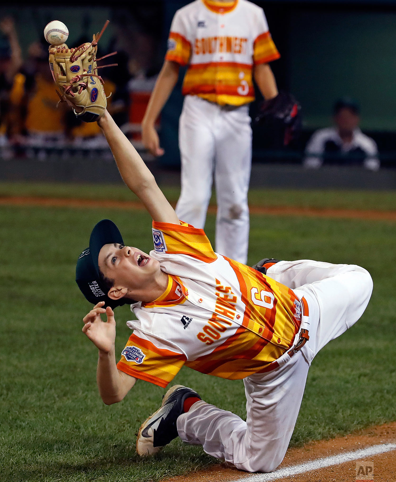 Houston, Texas' Carter Pitts (6) unsuccessfully reaches for a catch on an infield pop up by Peachtree City, Ga.'s Cayden Olvey (14) during the seventh inning of an elimination baseball game in United States pool play at the Little League World Series tournament in South Williamsport, Pa., Monday, Aug. 20, 2018. (AP Photo/Gene J. Puskar)