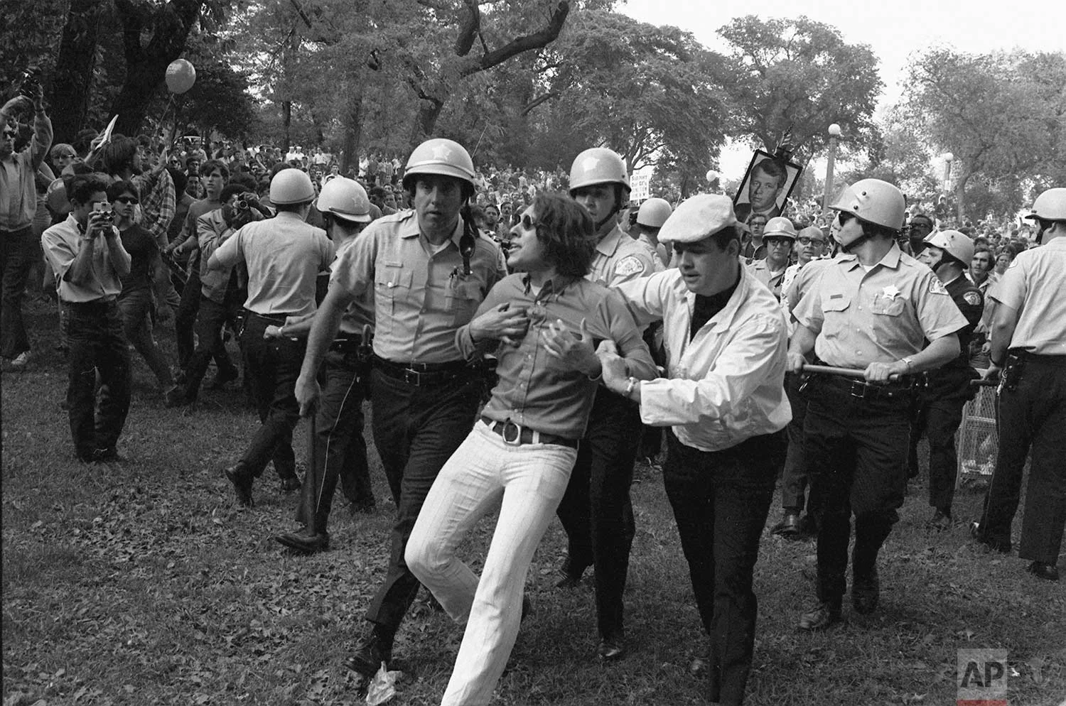 Chicago police lead a demonstrator from Grant Park during demonstrations that disrupted the Democratic National Convention in August 1968. The convention became the focal point of bitter confrontations between police and anti-war demonstrators. (AP Photo)