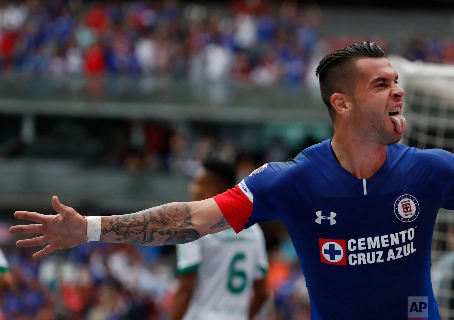 Cruz Azul's Caraglio Milton celebrates after scoring against Leon during a national league soccer match at Azteca Stadium in Mexico City, Aug. 18, 2018. (AP Photo/ Eduardo Verdugo)