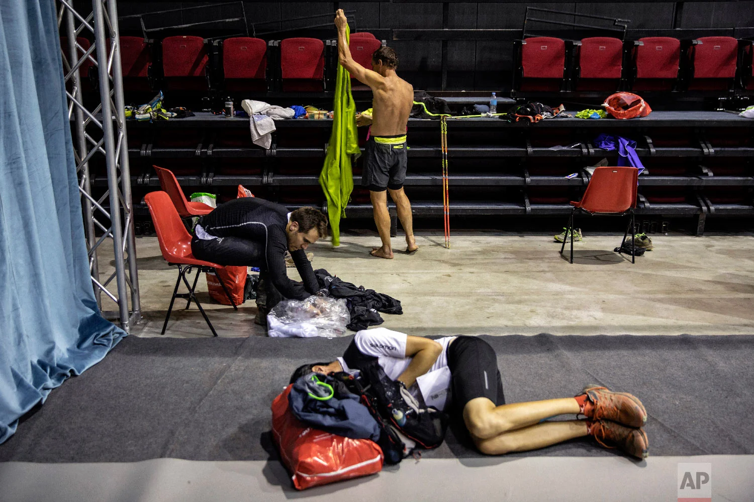 Competitors take some rest in the middle of the night at a refreshment post as they compete in the 170km Ultra-Trail of Mont-Blanc (UTMB) race, in Courmayeur, Italy, Sept 1, 2018. (AP Photo/Laurent Cipriani)