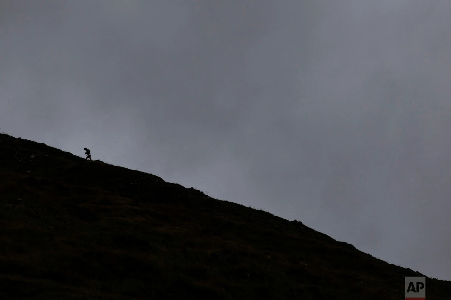 A competitor runs up the Grand Col Ferret as he competes in the 170km Ultra-Trail of Mont-Blanc (UTMB) race, near Courmayeur, Italy, Sept 1, 2018. (AP Photo/Laurent Cipriani)